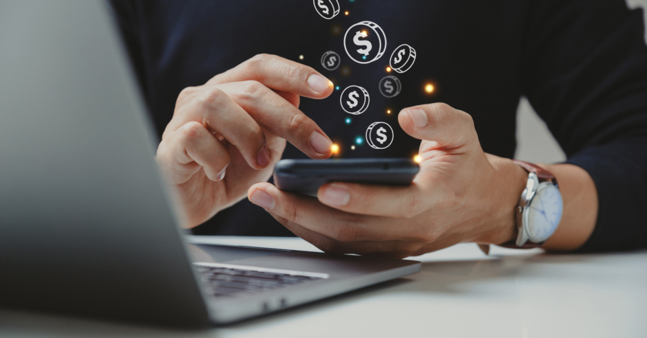 Hand of a businessman using a smartphone for payment, which is one of the newest commercial real estate technology trends