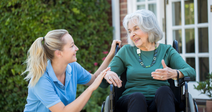 healthcare real estate, carer talking to senior woman