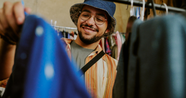 A smiling man shopping at a secondhand market